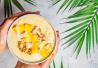 Kuvassa smoothiebowl, jossa on päällä mangoa, kookosta ja passionhedelmää