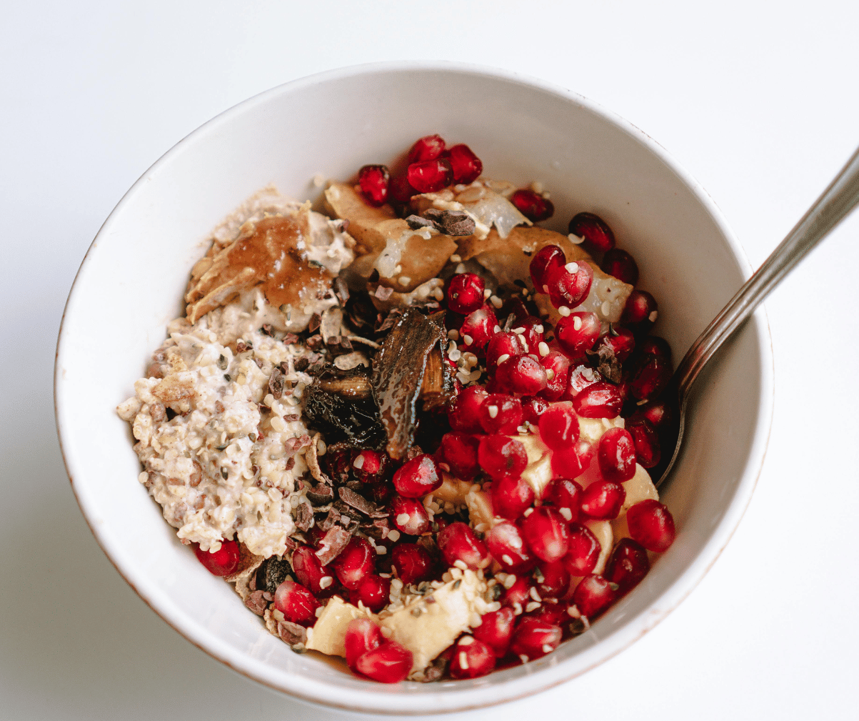 Kuvassa puuroannos, jossa maapähkinävoita, tummaasuklaata ja granaattiomenan siemeniä