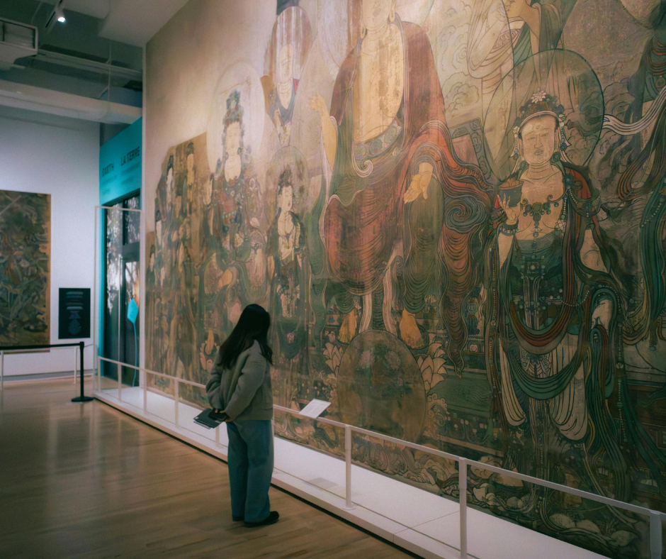 Nainen katsoo taulua museossa.